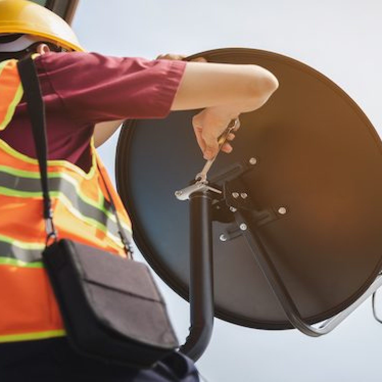 Young man technicians are installing satellite dish